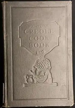 Books cover with embossed image of a woman with a bandana on her head stirring a bowl.