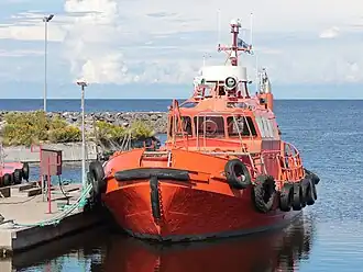 An orange-coloured pilot boat at berth in the Marjaniemí harbour in the Hailuoto Island, Finland