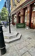 Pink kerbstone, site of original pump