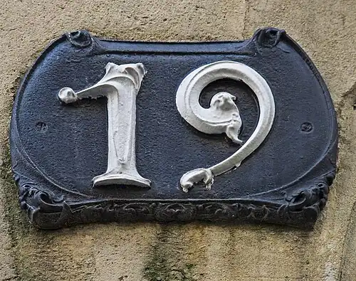 House number plaque at Castel Béranger