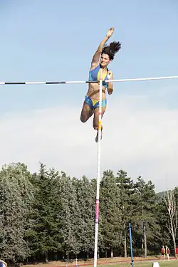 Image 12Anna Giordano Bruno releases the pole after clearing the bar in pole vault (from Track and field)