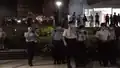 Police officers are preparing to intercept and search people at the waterfront location