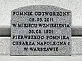 The plaque at the base of the monument.