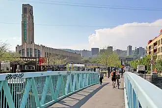 The pedestrian and bicycle bridge across the Lachine Canal heading towards the Market