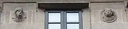Two of the heads on the front, the first with glasses