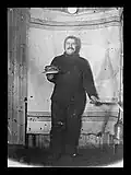 Adolf Lindstrøm with a plate of pancakes at Framheim in 1911.