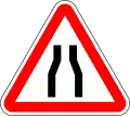 Road narrows on both side
