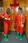 CDC microbiologists in Delta Protection "Orange Suits"