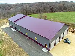Image 6Post frame Barndominium with standing seam metal roof. Large garage on the front side and living space on the back end. (from List of house types)