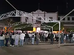 Many people gather in a public square.