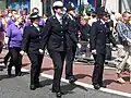 British police officers wearing the female and male variants of current British police tunics.