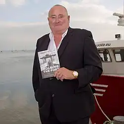 Bates in 2015 posing with his book