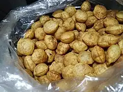 A pile of small puris with dark, coarse appearance