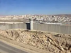 Israeli watchtowers and wall at the checkpoint of the Palestinian refugee camp of Qalandia, 2014