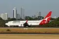 Boeing 737-800 at Perth Airport with the city of Perth in the background (2004).