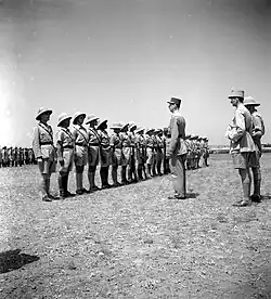 The French general Charles de Gaulle (tall man in the middle) visiting Camp Qastina in May 1941