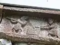 A large block of stone is shaped.