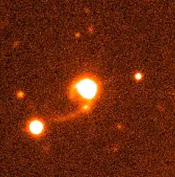 This photograph shows an image of the Quasar HE 1013-2136 (center) and its surroundings.