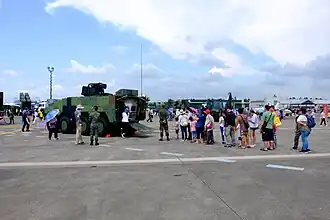 Queue of Visitors Waiting for aboard CM-32 Yunpao APC at Gangshan Air Force Base