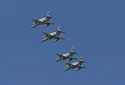 Four monoplane aircraft flying in close formation. The aircraft are painted grey and have been photographed from below.