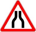 Road narrows on both sides
