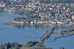 Rapperswil as seen from Etzel mountain: Capuchin monastery to the left, Rapperswil castle and St. John's church in the background, Lake Zurich harbour and Altstadt in the foreground respectively Seedamm, wooden bridge and upper Lake Zurich to the right (October 2010)
