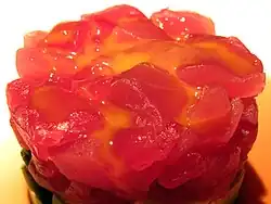 Raw quail egg yolk served over chunks of maguro (raw bluefin tuna) at a sushi restaurant in Naugatuck