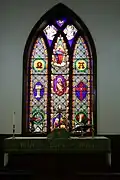 The altar and central stained glass window