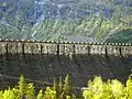 The dam is crowned by the dates 1910–1918 and initials of the managing director Ragnvald Blakstad. The letters are 4&nbsp;m high