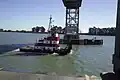 A boat passes under the Rio Vista Bridge