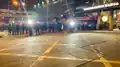 Riot police use spotlights on Yen Chow Street.