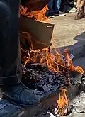 The feet of the statue, with fires set beneath them