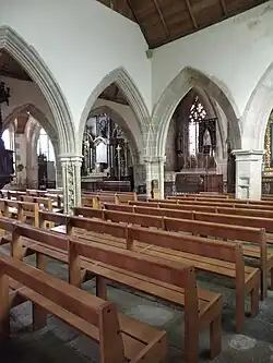 Photograph of a church chapel, with Gothic arcades opening onto the rest of the building.