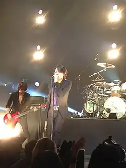 Ryuichi (center) performing with Luna Sea in Singapore, 2013
