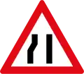 Roadway narrows from the left side ahead