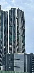 Tall residential building with a glass facade.