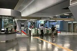 Commuters entering the fare gates from Entrance B of the station