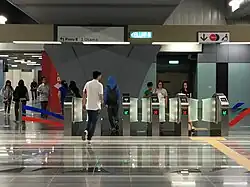 Commuters using the fare gates leading to Entrance B of the station