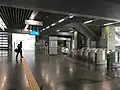 Unpaid area and fare gates at the concourse level of the station