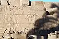 Seshat (third from the left) shown performing the "stretching the cord" ritual with Ramesses II (second from the left). Sunken relief at the Karnak Temple Complex.