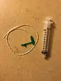 Equipment for supplemental nursing system using syringe