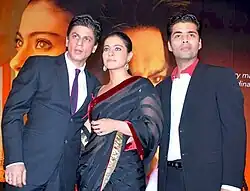 Shah Rukh Khan, Kajol, and Karan Johar pose for the camera.