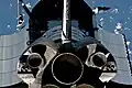 A view of the aft portion of Discovery's main engines, part of the payload bay, vertical stabilizer and Orbital Maneuvering System pods during the RPM.