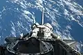 Atlantis' payload bay, vertical stabilizer, OMS pods and docking mechanism