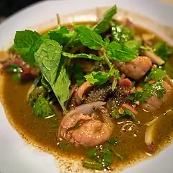 Sa nuea sadung is a northern Thai "salad" of semi-raw beef cuts, including sliced stomach. This particular version also contains nam phia, which are the contents of the first stomach of a cow.