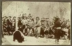 (3) Bear tied to stake, and shot with the heper-ai (the blunted "cub-arrows"). A 1914 photo.