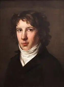 Painting of a handsome young man with wavy brown hair. He wears a black coat open at the neck to reveal a white shirt and collar.