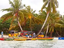 Dugout canoes ferry passengers between Nosy Boraha and Île aux Nattes.