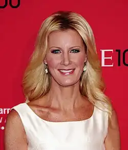 A women with blond hair, wearing a white outfit
