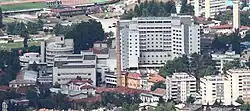Aerial view of a large complex of white hospital buildings.